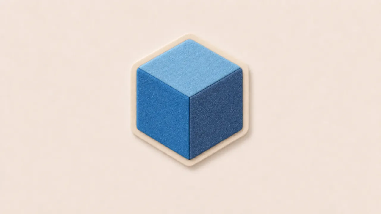 A felt cube in three shades of blue on a cream backing