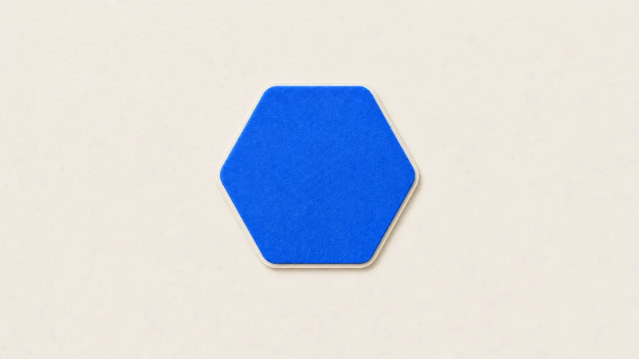 A blue paper hexagon holding a white paper magnifying glass over a paper bar chart