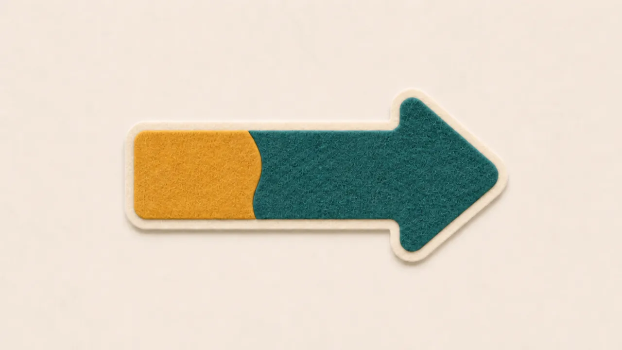 A paper arrow with a yellow tail joined to a teal head along a curved seam
